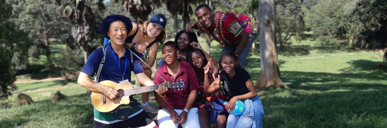 Servas youth members with guitar outside in Uganda